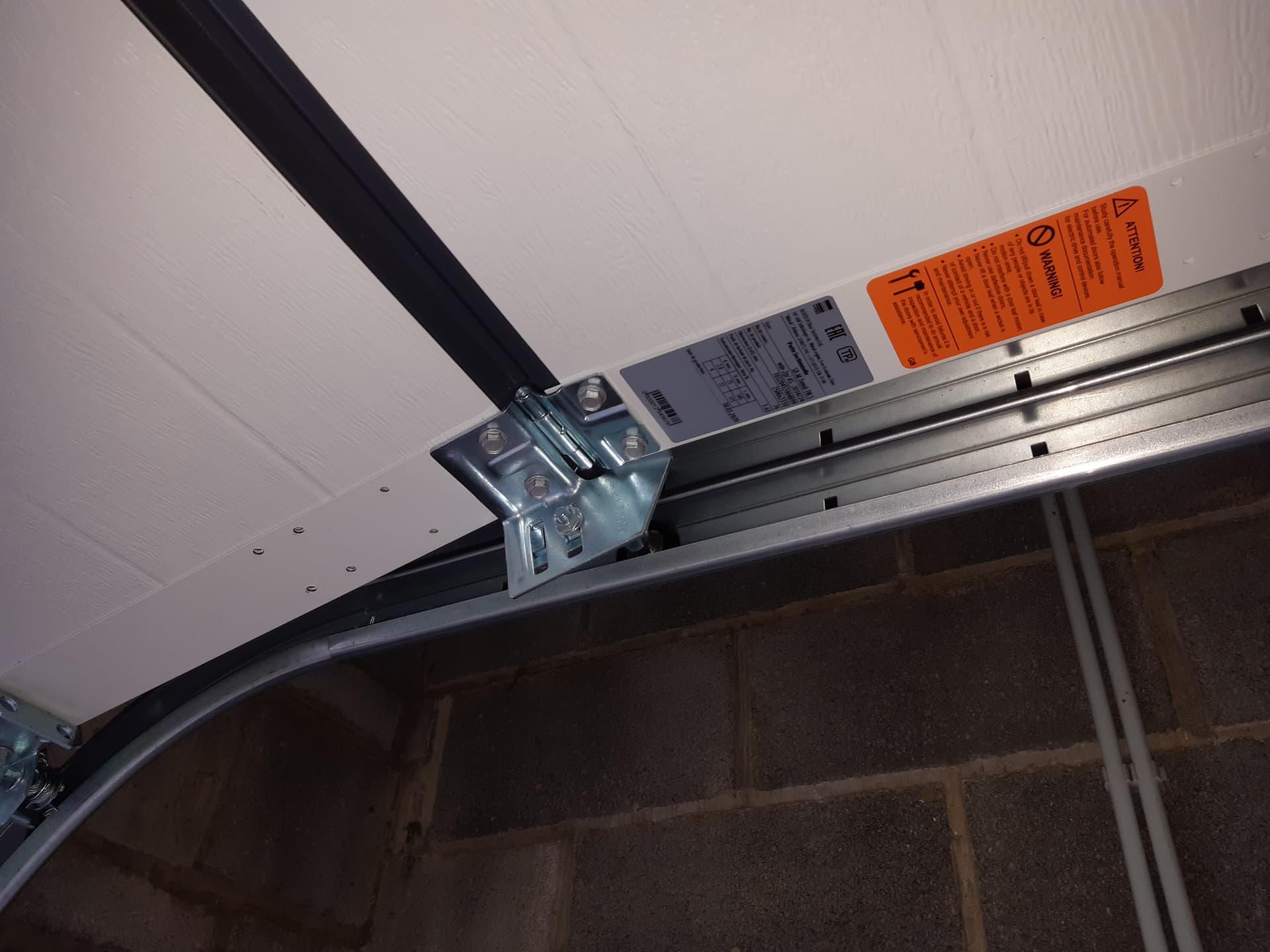 Détail des ferrures et du rail d'une porte de garage sectionnelle